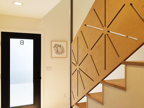 Entryway and stair up to the top floor.