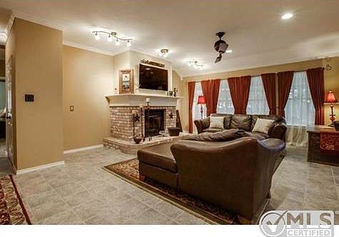 Large family room with wood burning fireplace and tiled floors