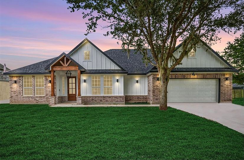 Beautiful curb appeal and landscape lighting. Mature oak trees line the driveway and backyard.