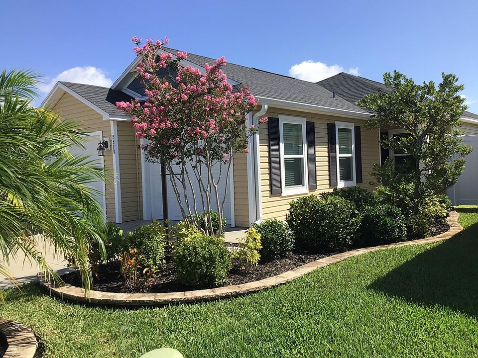 Two car garage with separate doors. Main entrance on side with beautiful landscaping