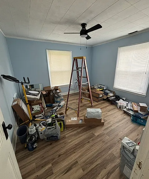 Bedroom 1. (Currently storage area, house still being worked on.) Left window looks into front yard.