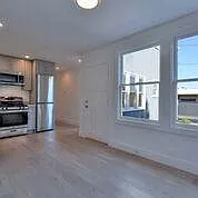 Kitchen and living area with rear exit to courtyard.
