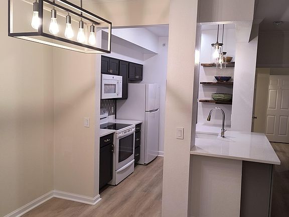 Large island with quartz counter top open to dining area/ greatroom.