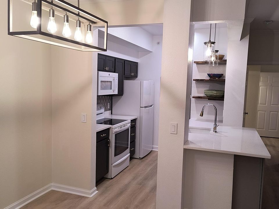 Large island with quartz counter top open to dining area/ greatroom.
