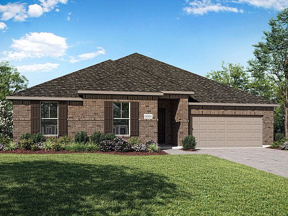 A single-story brick house with a peaked roof sits on a well-manicured lawn, surrounded by lush gree