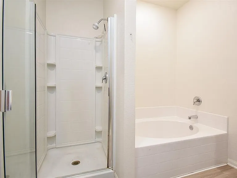 private master bathroom with walkin shower and tub