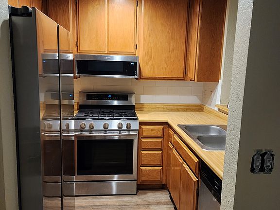 Kitchen has Microwave, Gas Burning Stove/Oven, Dishwasher, Disposal and Refrigerator