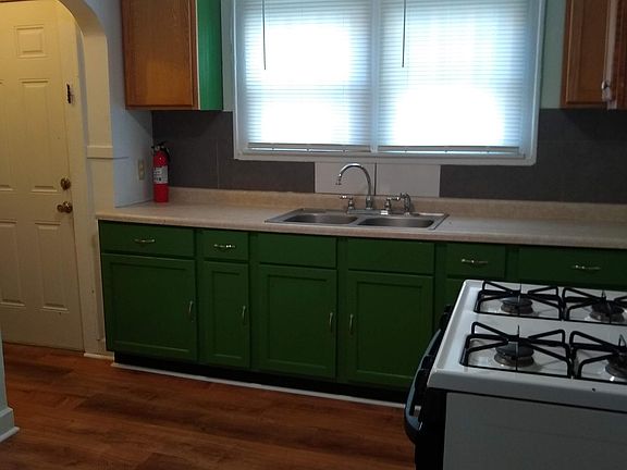 New floor in kitchen and freshly painted cabinets.