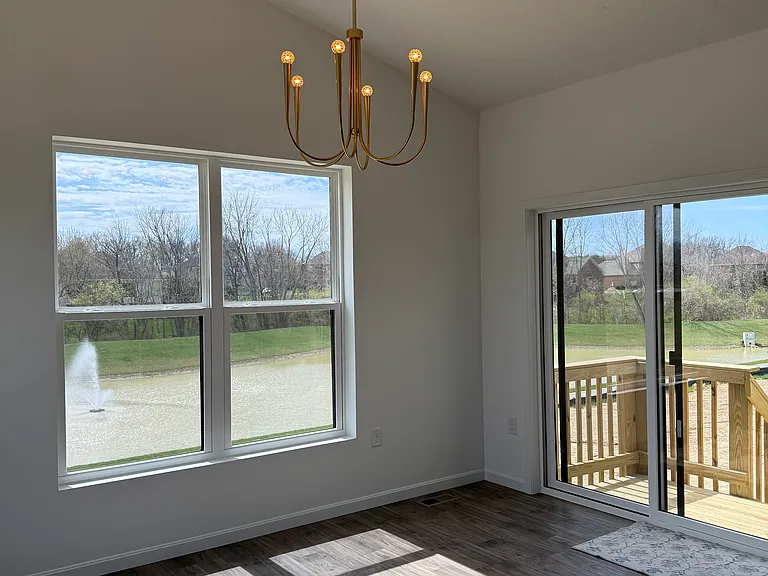 Dining room overlooking pond and deck / patio area