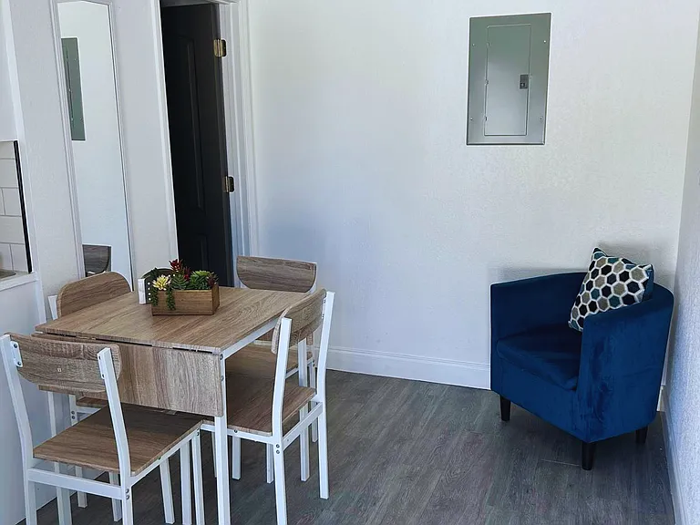 Dining area with 4 chairs and a homely accent chair.
