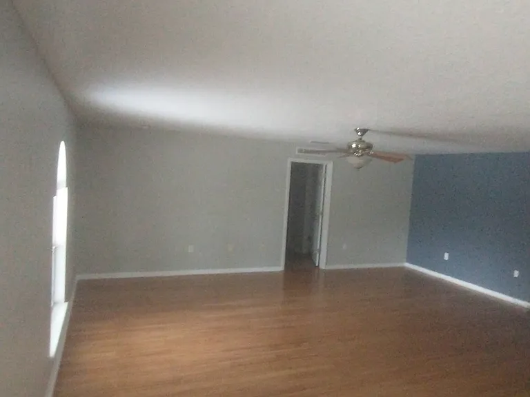 Downstairs main living room with bamboo floors and view of pool. Entrance to downstairs master bedroom seen on other side of room.
Room Size 18' x 20.5 '