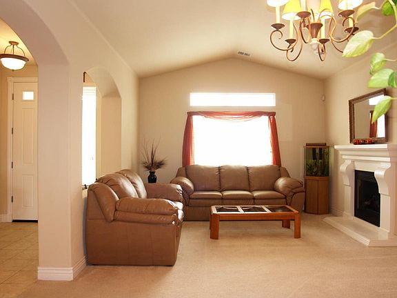 Living Room with Hearth & Fireplace High ceilings