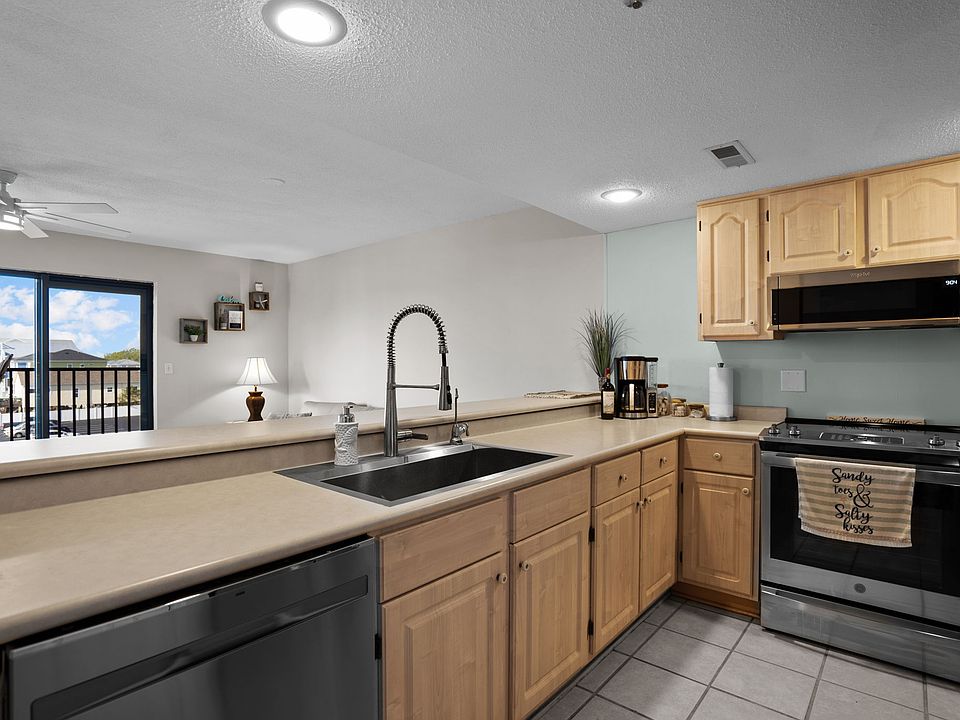 Kitchen overlooking living/dining and part of the slider/windows.