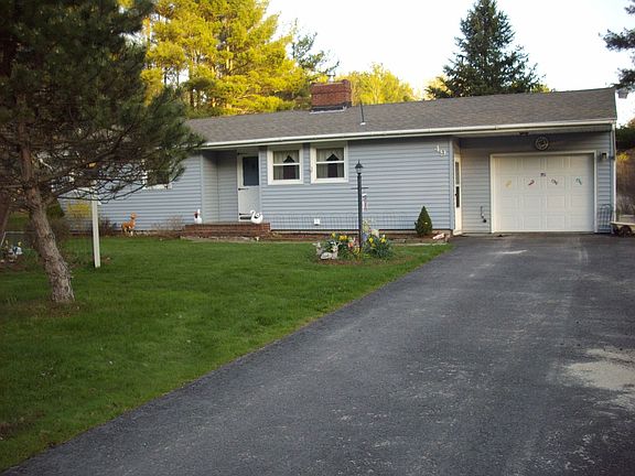 Front of house with detached one car garage