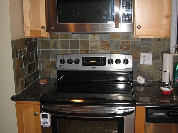 Ceramic stove, microwave, tile backsplash