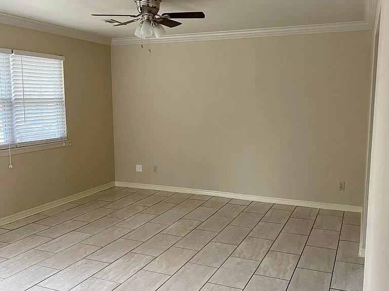Living room has double windows with blinds. Dining area has single window.