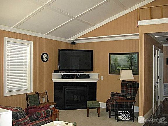Spacious living room with gas-log fireplace and home theater system. Head down the hall to the bedrooms, full bath and laundry/broom closet. Full-size front-load stack washer and dryer convey!
