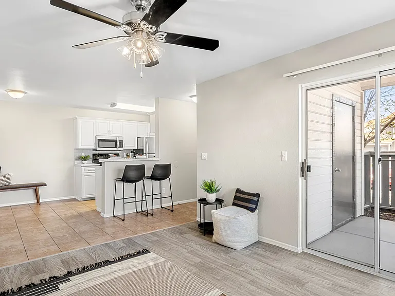 Sunlit open floor plan with tiled dining area, connecting effortlessly to the living room and kitchen.