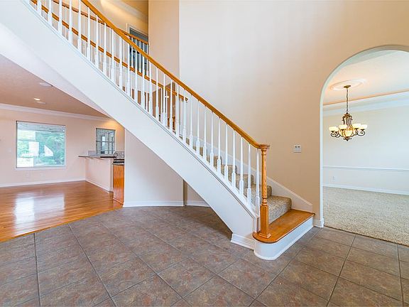 Tile floors welcome you into this beautiful home and escort you past the study and formal dining room towards the open family room - kitchen area overlooking the tropical paradise.