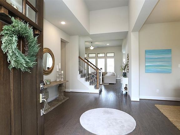 Upon entering you are greeted with a beautiful front door and high ceilings in the foyer.