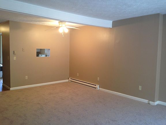 Living room and dining room with glass sliding doors leading to private patio