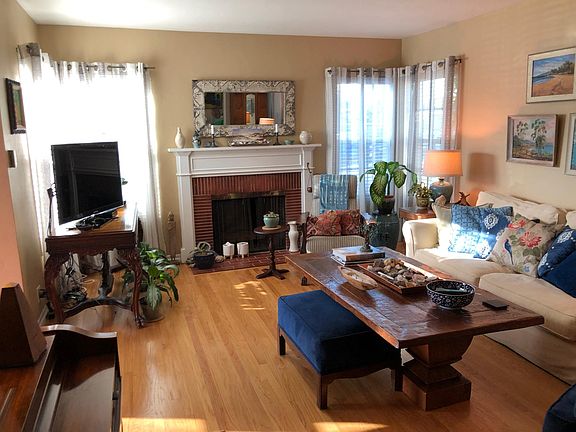 Large family room features a fully functioning fireplace and plenty of room for seating and even a piano!