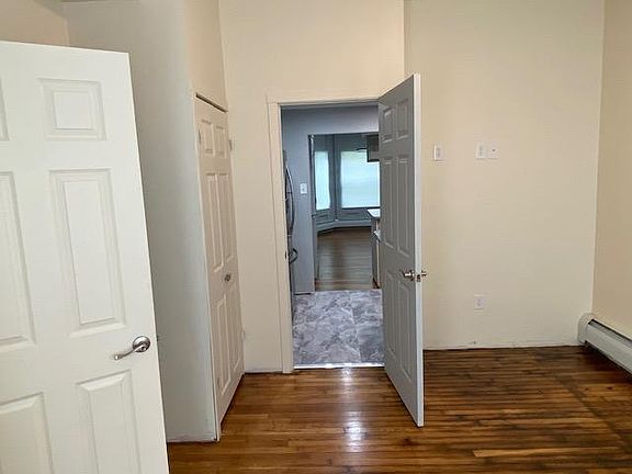 From the primary bedroom looking out into the kitchen and living room