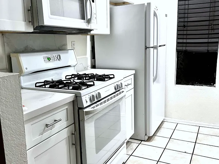 Kitchen: Gas, Oven, Microwave, Refrigerator in very good condition, neat and clean. Tiles on the floor. LED lights on ceiling.