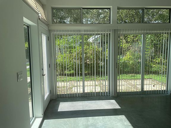 Bright, light and airy living room with glass sliding door to patio.