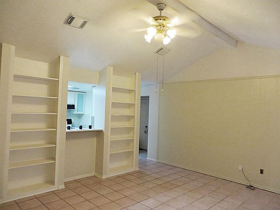Large family room (17x15) with built in shelves from floor to ceiling and breakfast bar overlooking kitchen.