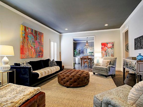 Formal Living Room offering tile flooring, designer paint & recessed lighting.