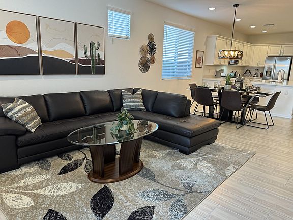 View of living room with dining and kitchen in background