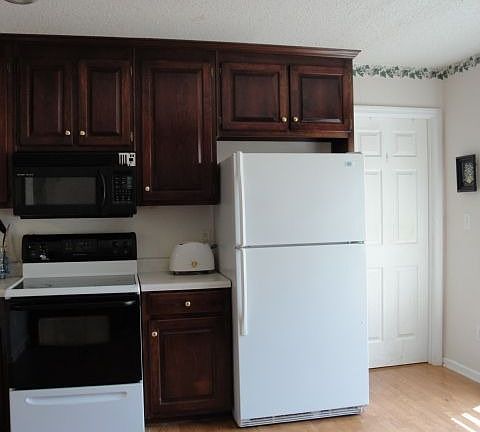 Kitchen w/ door to laundry room & garage