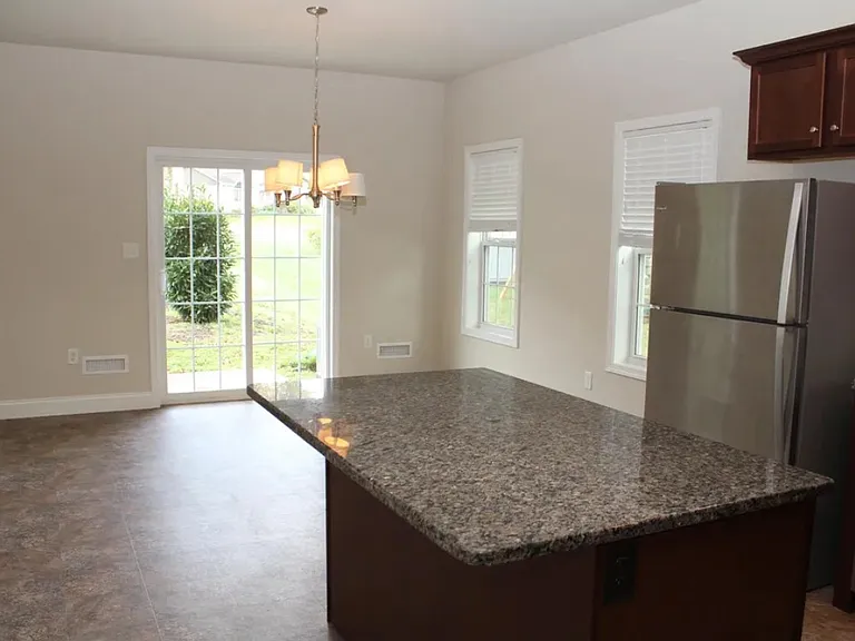 Open kitchen to dining area and walkout patio