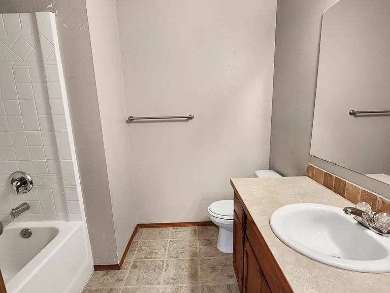 Full upstairs bathroom with tub/shower combo and ample counter space.