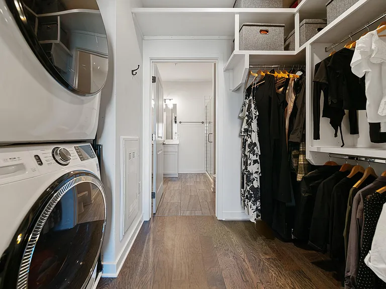 Custom closet with floor to ceiling storage and in-unit washer & dryer