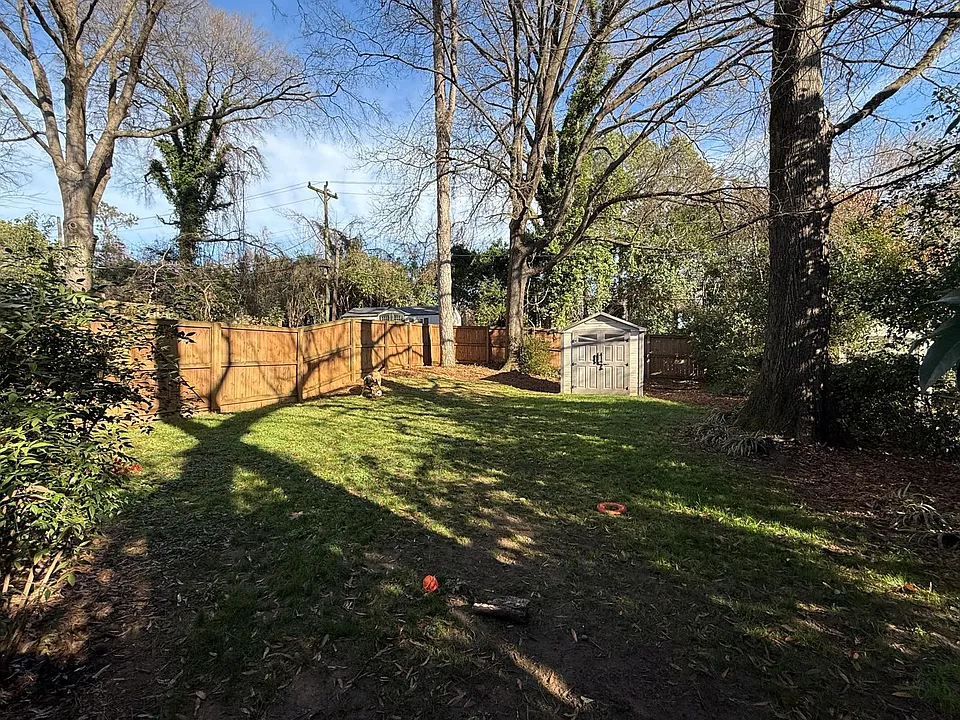 Fenced in backyard with storage shed
