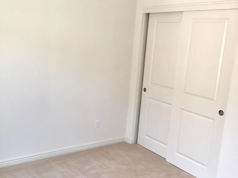 Bedroom 1 on the second floor with plenty of natural lighting, and large closet space.