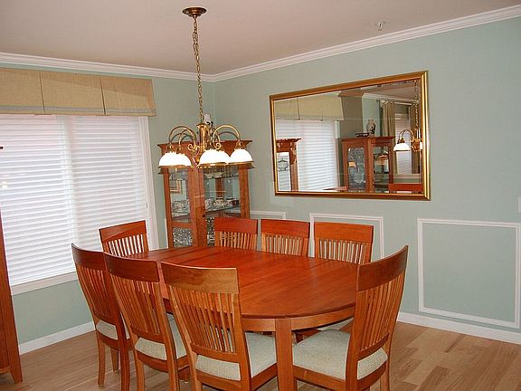Dining room shows wainscotting & crown molding