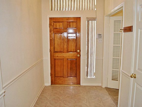 IMPRESSIVE TILED ENTRY AND WOOD DOOR