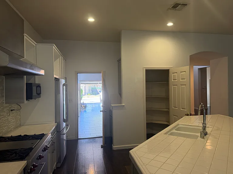 Kitchen showing great pantry space and Wolf stove!
