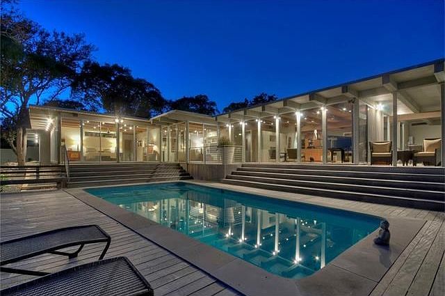 Twilight by the pool. Classic Palm Springs modern design with walls of glass and tons of outdoor living.