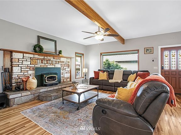 Front door entry, living   room with wood burning fireplace. Beam was added for support.