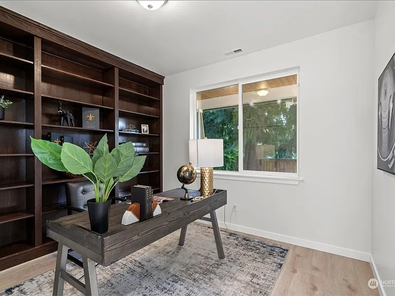 Office Den with closet and display shelves on first floor