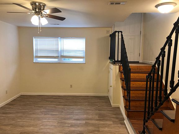 The split foyer design is a bit unique - front door top right with the 2nd set of stairs leading to the bedrooms. This is the living room with LVP flooring.
