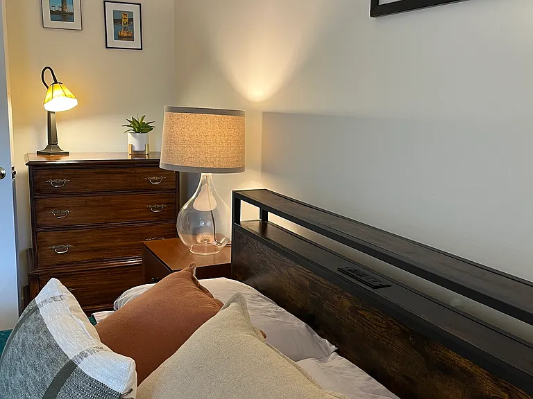 Second bedroom offers new full mattress and bed frame with outlets for charging devices. Full closet and room darkening shade.