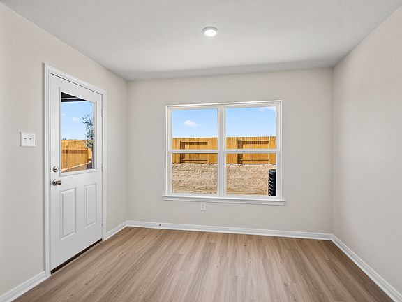 The adjoining dining room is spacious and inviting with a view of the backyard.