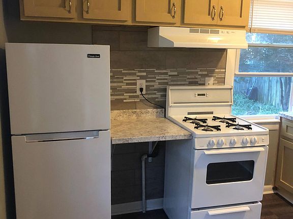 Brand new fridge and hood range.