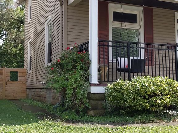 Enjoy this lovely porch or enter the gate into the huge fenced back yard!