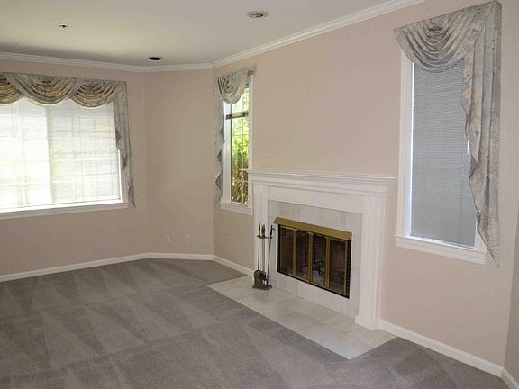 Living room with fireplace (note that these pictures were taken before existing tenant, and window coverings may have changed).